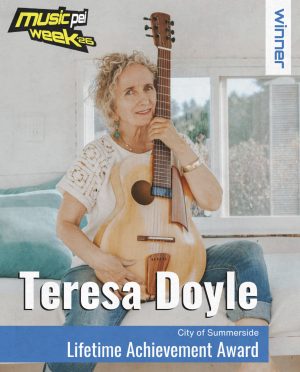 Teresa Doyle with guitar in announcement for Music PEI's Lifetime Achievement Award.